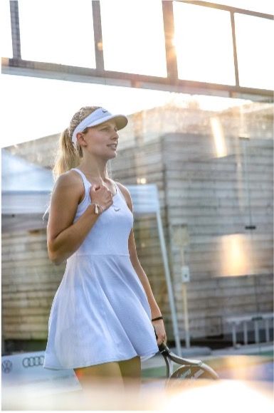 Female padel instructor Lisa demonstrating proper serve technique