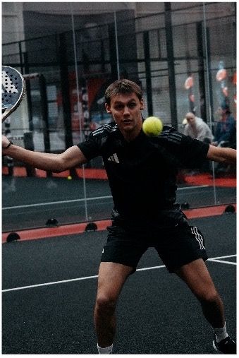 Professional padel trainer Marco in action pose with racket