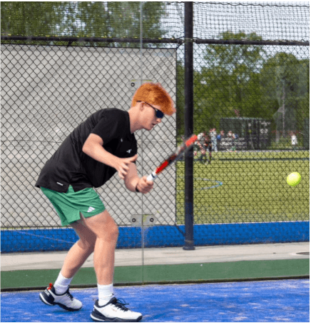 Young energetic padel trainer Sophie coaching junior players